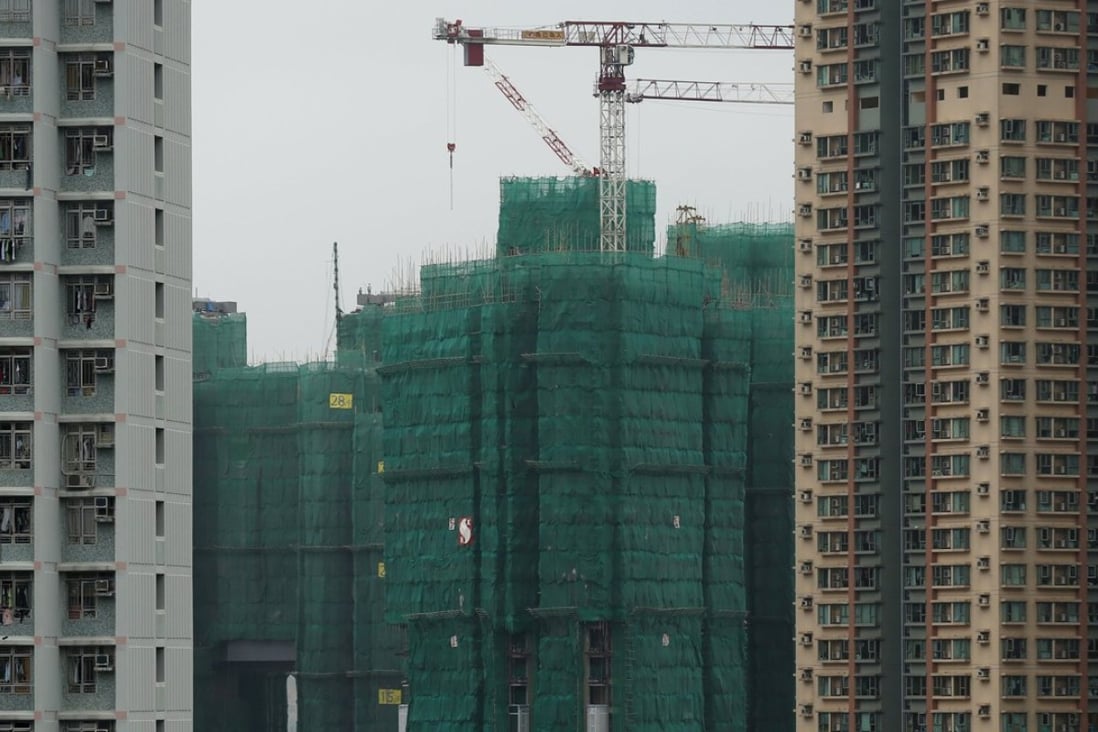 Construction cranes are seen at the building site of a new private housing complex in Hong Kong, China as falling flat prices have brought them back to their levels in early 2014. Photo: Reuters