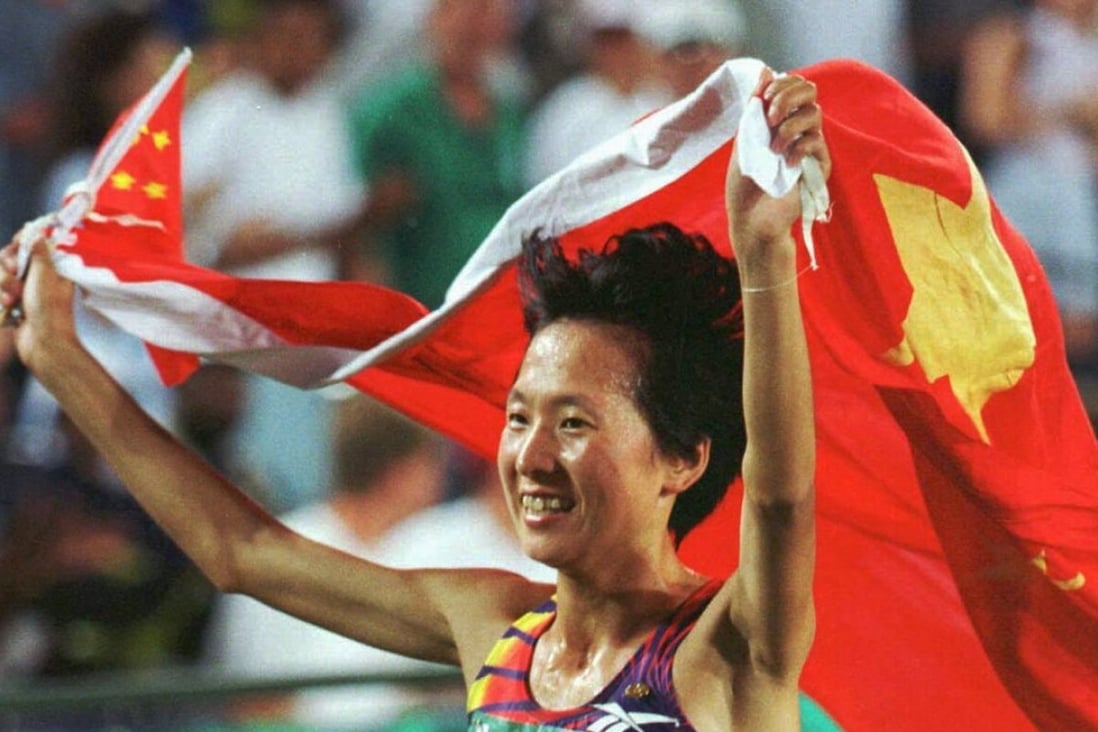 Wang Junxia drapes herself in the Chinese flag after winning the 5,000m race at the 1996 Atlanta Olympics. Photo: Reuters