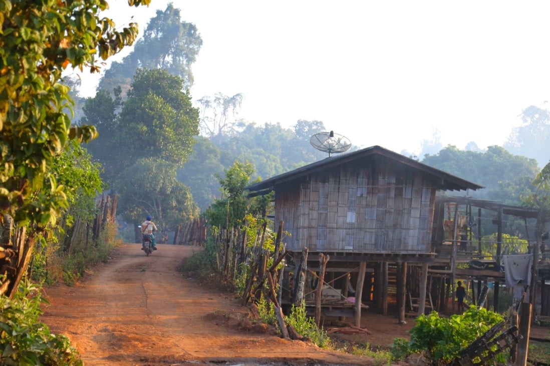 A motorbike makes its way through the village of Pha Mon in the early morning. Photos: Graeme Green