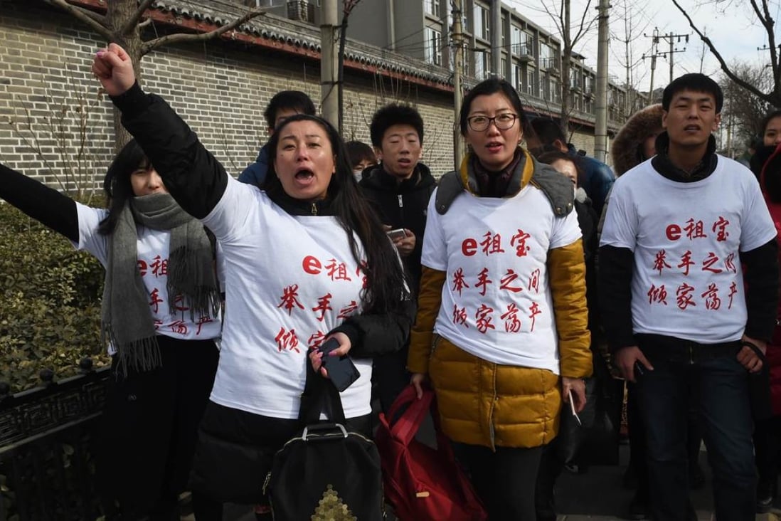 Investors in Chinese online peer-to-peer lender Ezubao chant slogans during a protest in Beijing on February 4. Photo: AFP
