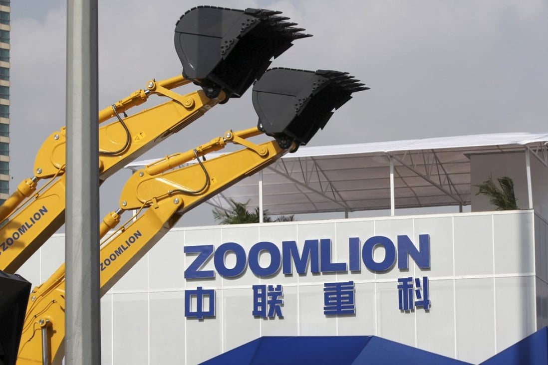 A Zoomlion company logo is seen next to its excavators at an exhibition in Shanghai, in this November 29, 2012 file photo. Photo: Reuters