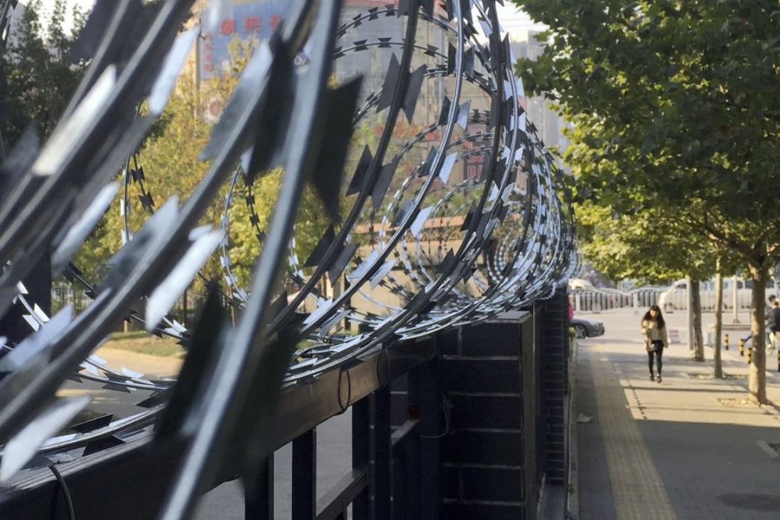 Barbed wire protects a residential compound in Beijing. The Chinese government plans to open all gated communities to the public, causing concerns over security and private property rights. Photo: Simon Song