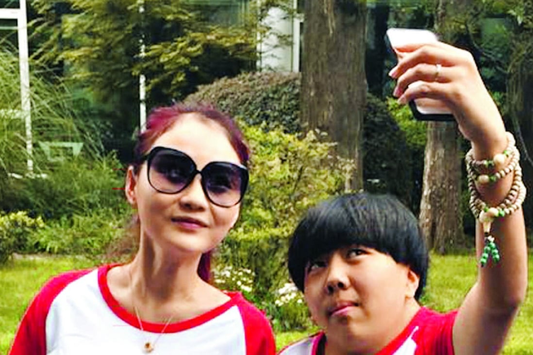 Shen Hui Hui (right), 20, takes a selfie with her idol Shen Man (left) in matching shirts at a fan meeting in Hangzhou in 2015.