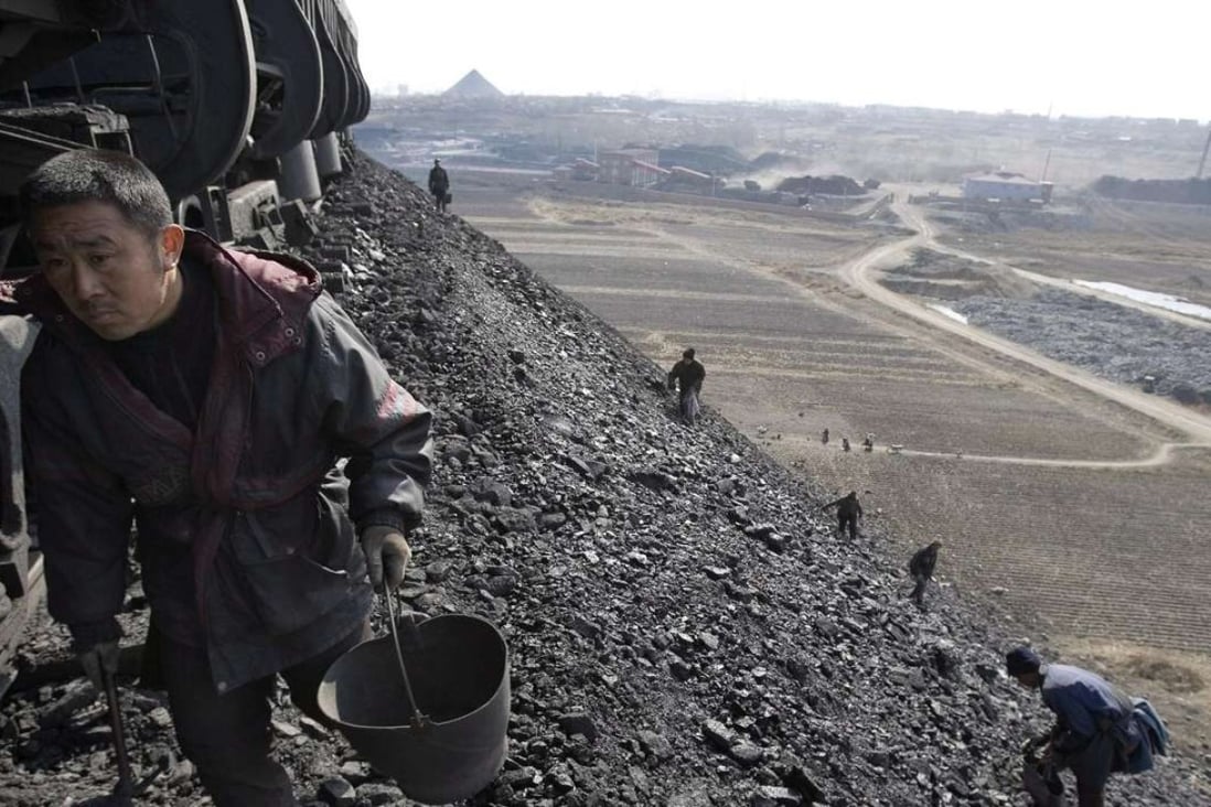 A Chinese man collects low-grade coal on the outskirts of a city in China’s northern Heilongjiang province. Photo: EPA