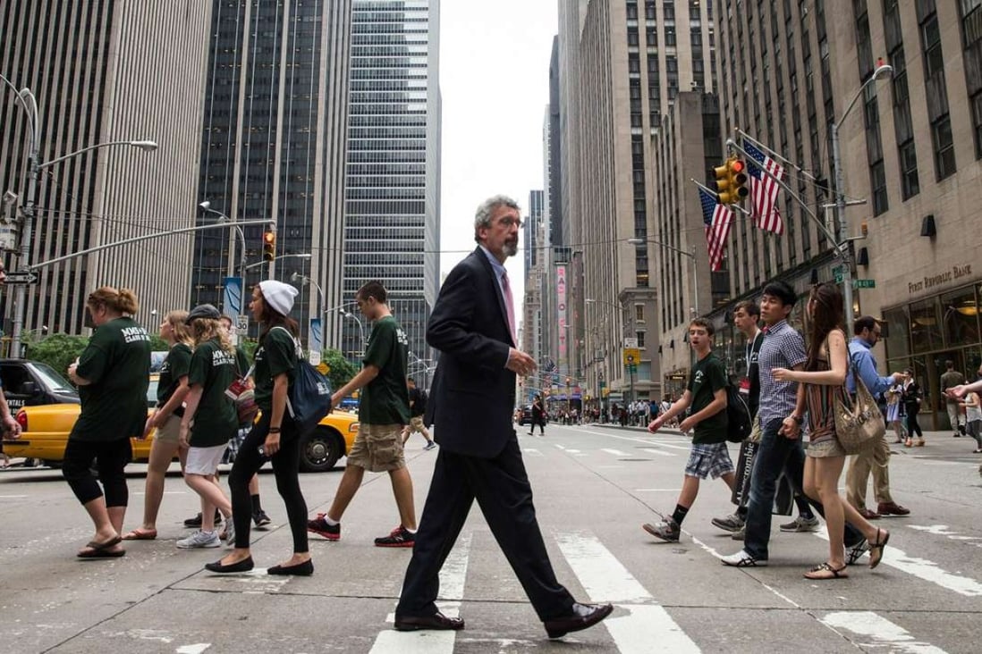 Pedestrians cross Manhattan’s Sixth Avenue, also known as Avenue of the Americas. Photo: AFP