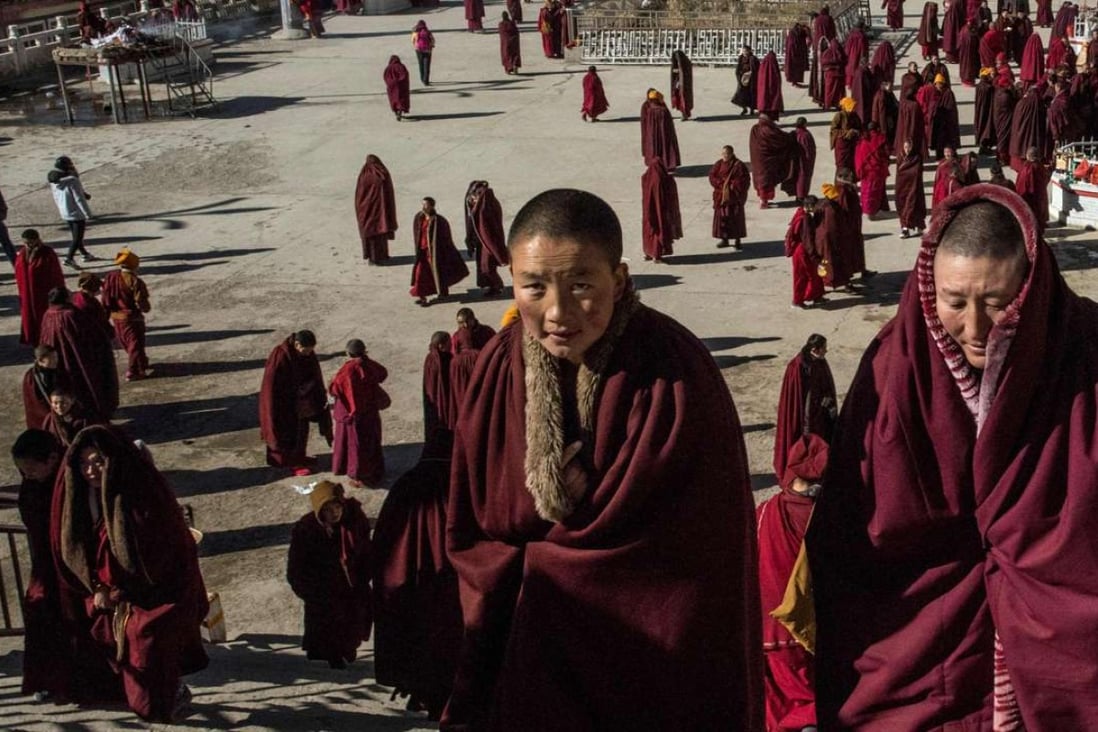 Buddhist nuns leave the monastery after praying at the Larung Gar Buddhist Institute in Sertar county (known as Seda in Chinese) in the remote Garze Tibetan Autonomous Prefecture in China’s Sichuan province. Photos: AFP