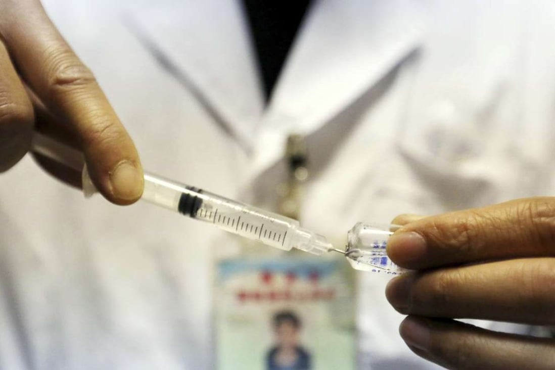 A health worker prepares a child's vaccination at a health station in Rongan county in Guangxi. Photo: AP