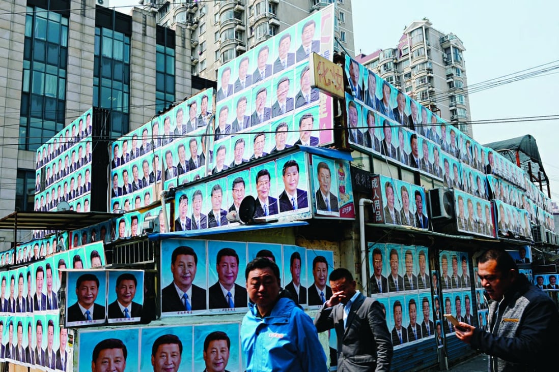 A prefabricated building, reportedly illegally constructed in Shanghai, seems to have been spared the bulldozer after being covered in posters of President Xi Jinping. Photo: SMP Pictures