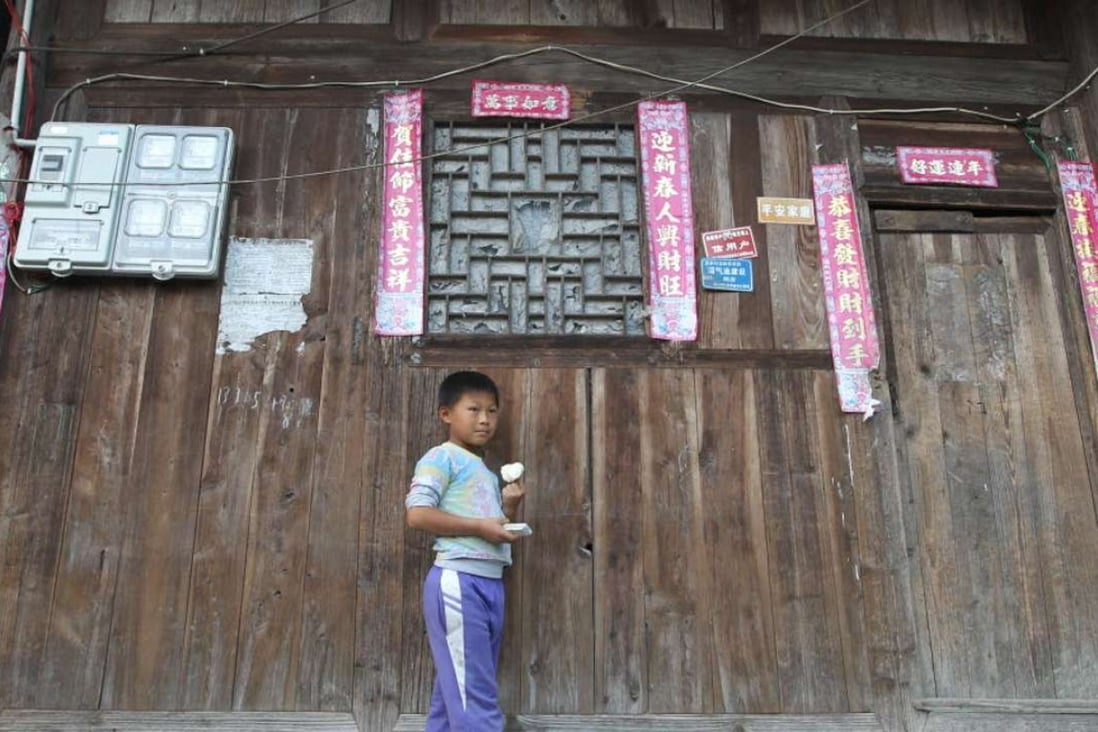 Xiong, 8, is a third grade pupil whose father is a migrant worker and leaves him living with his grandmother in a village in Weng’an county, southwest China’s Guizhou province. Almost all children in the village are left-behind children. Photo: Simon Song