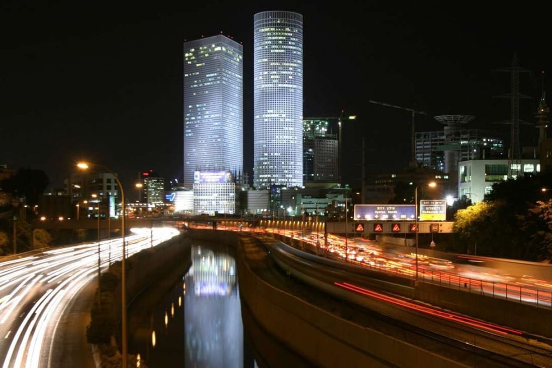 Rush hour traffic seen on the Ayalon Highway under the Azrieli Towers that dominate the Tel Aviv skyline. Photo: EPA