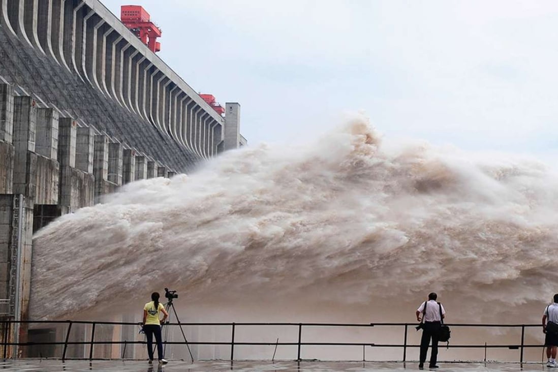 People observe water being discharged at the Three Gorges Dam, which spans the Yangtze River, in China’s central Hubei province. The river is expected to experience severe flooding this year. Photo: Xinhua