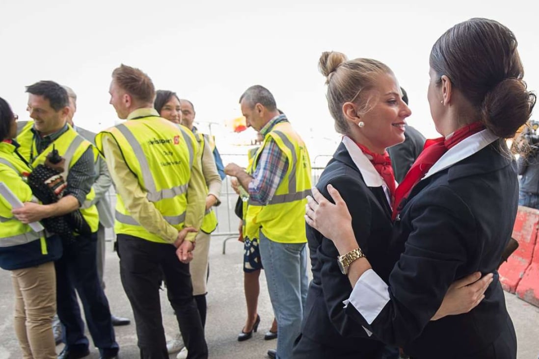 Emotional Brussels airport employees celebrate on Sunday after the first flight since the recent terrorist attacks took off from Brussels’ Zaventem Airport. Photo: AFP