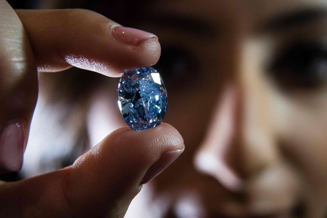 The ‘De Beers Millennium Jewel 4’, a rare Oval Internally Flawless Fancy Vivid Blue Diamond weighing 10.10 carats – the largest oval fancy vivid blue diamond ever to appear at auction Photo: AFP