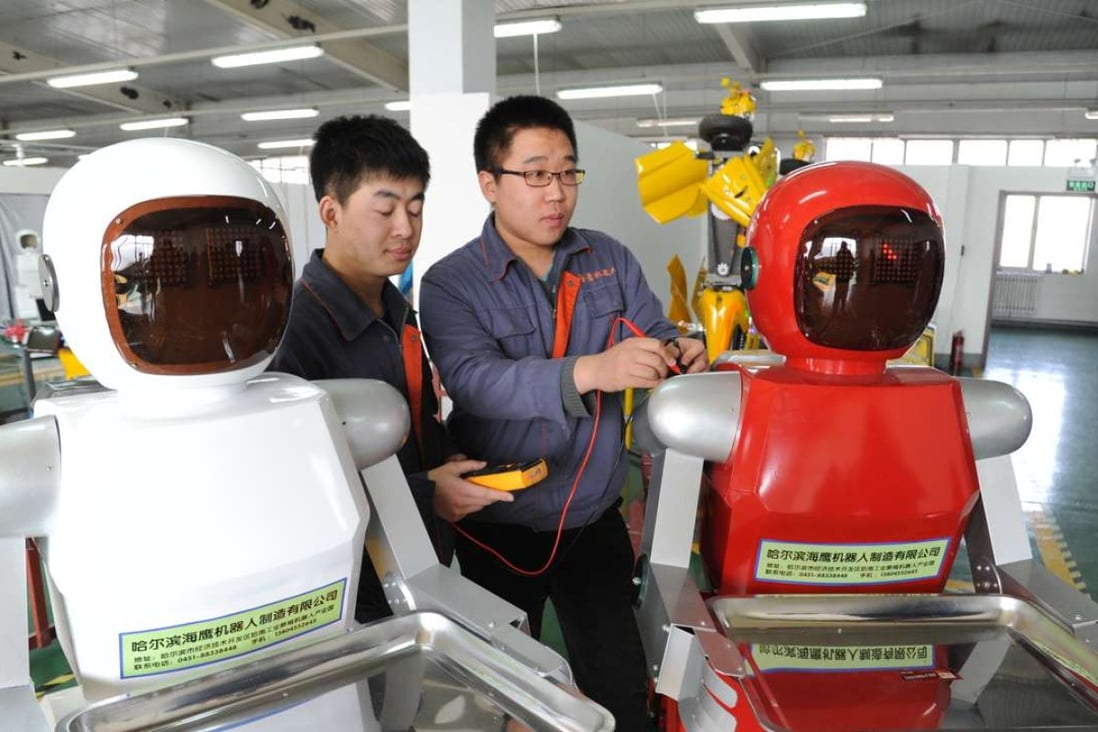 Workers check newly produced robots designed for the service industry in Harbin, Heilongjiang province. Photo: China Foto Press
