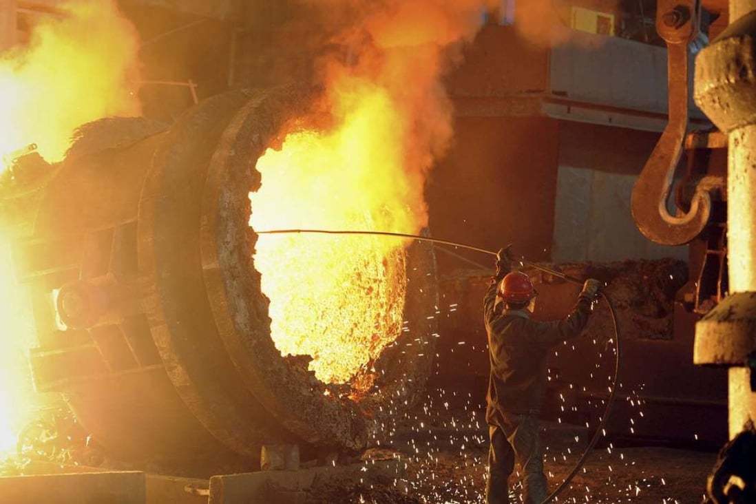 A steel worker operates a furnace at a steel manufacturing plant in China. Photo: Reuters