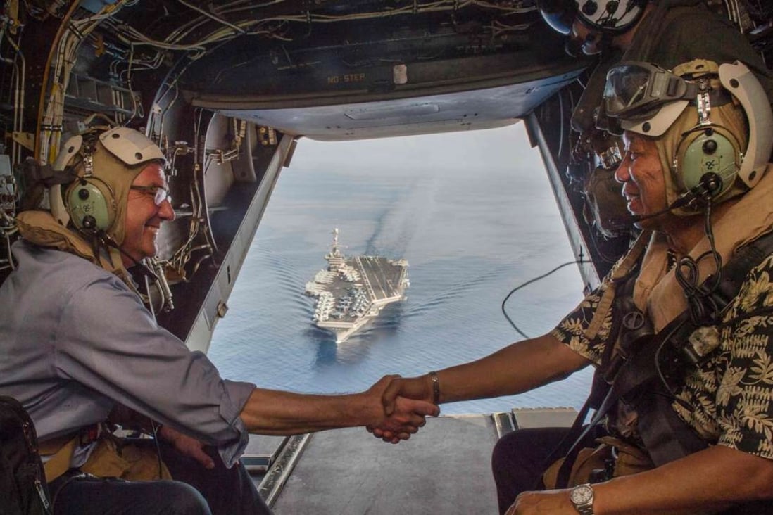 US Secretary of Defence Ash Carter and Philippine counterpart Voltaire Gazmin depart the USS John C. Stennis. Photo: AFP