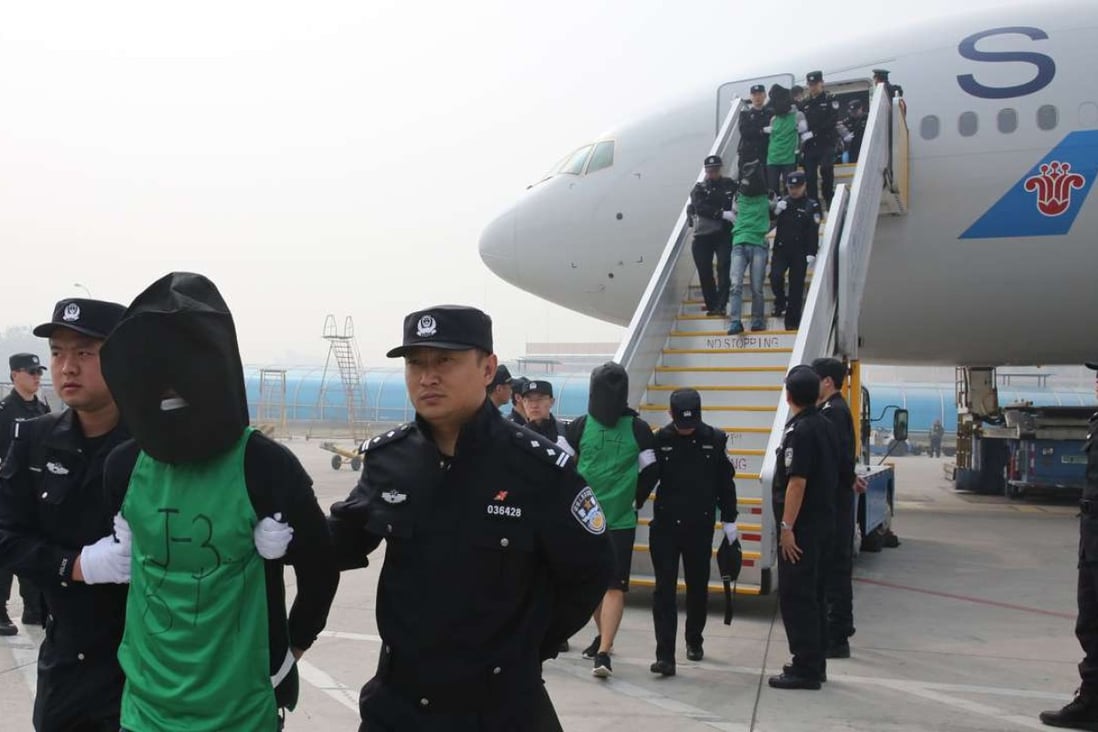 Tlecom fraud suspects deported from Kenya arrive at Beijing Capital International Airport in Beijing. Kenyan police deported 77 suspects, including 45 Taiwanese, to the mainland. Photo: Xinhua