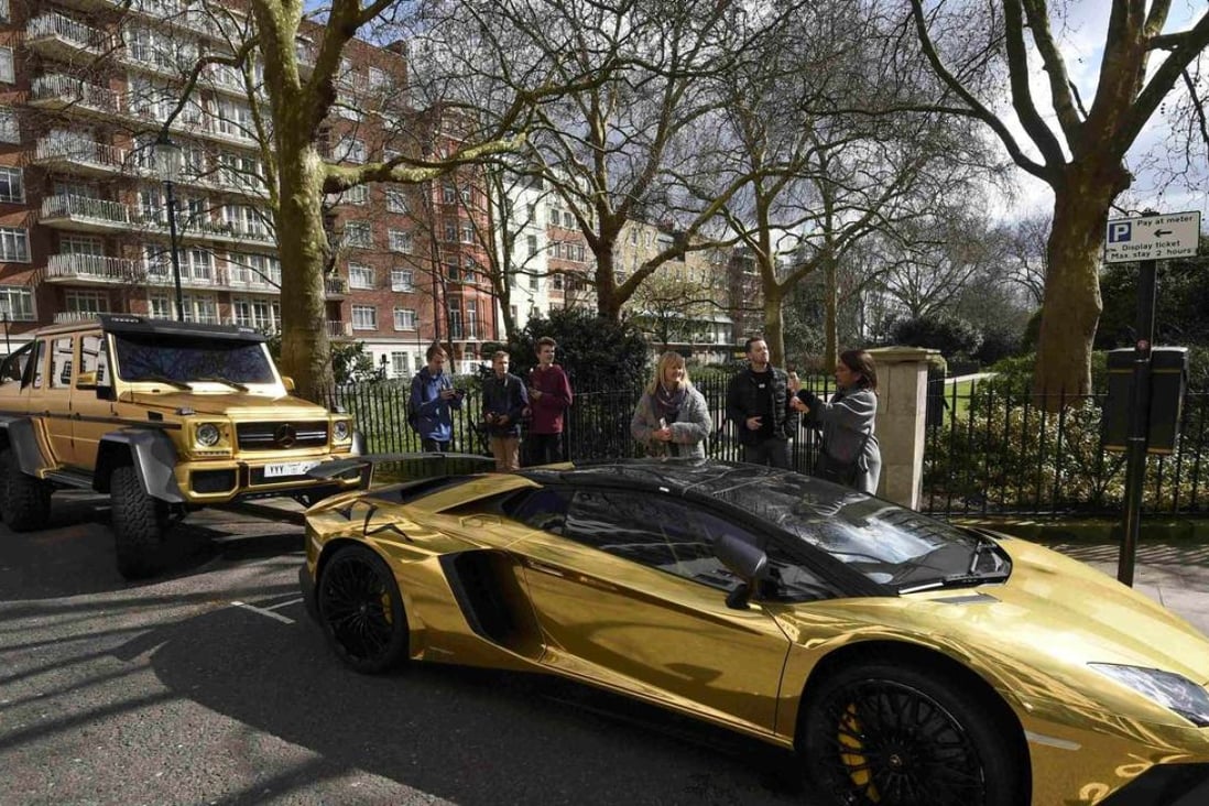Super cars with a gold wrap finish are seen parked in a street in Knightsbridge in London on March 31, 2016. Photo: Reuters