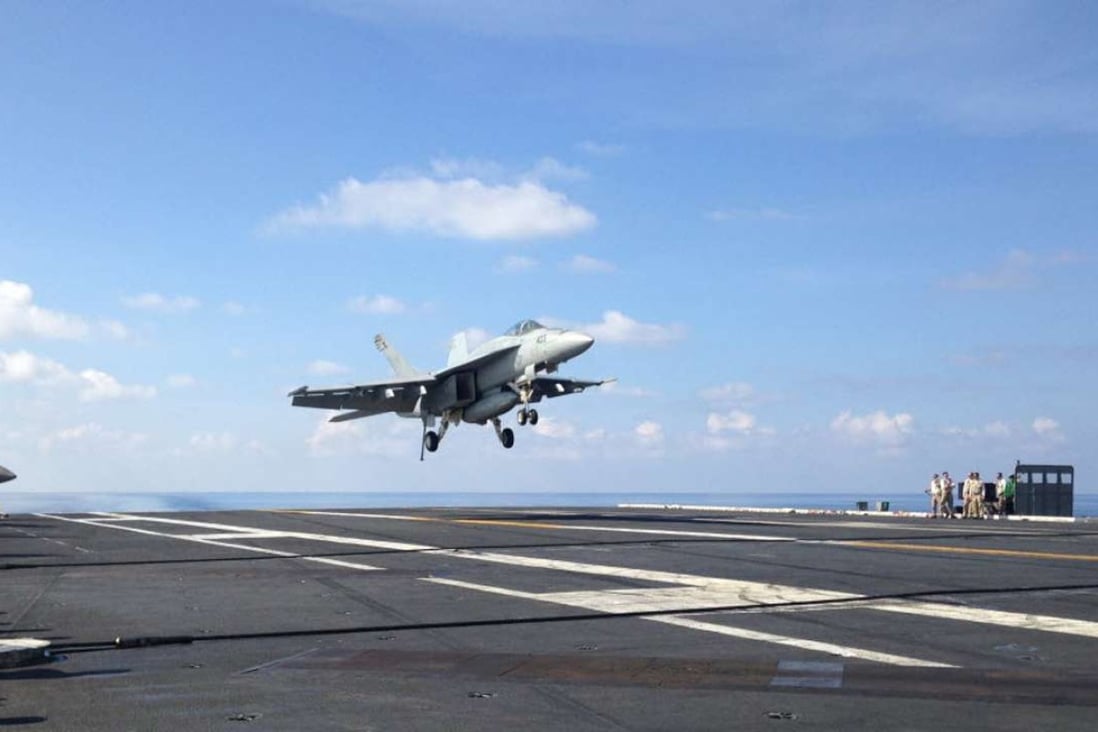 An FA-18 jet fighter takes off on the USS John C. Stennis, an American aircraft carrier in the South China Sea on Friday, April 15, 2016. US ships have started conducting joint patrols in the South China Sea with the Philippines. Photo: AP