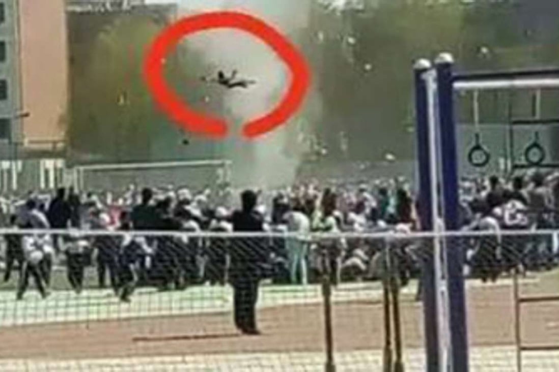 A photograph shows the mini tornado lifting primary school student Li Jiaqi into the air during his school’s sports day on Wednesday. Photo: Chinayouth.com