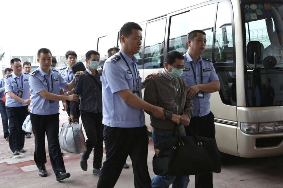 Fugitives allegedly involved in economic crimes are escorted at Beijing Capital International Airport in June 2015. Photo: Xinhua
