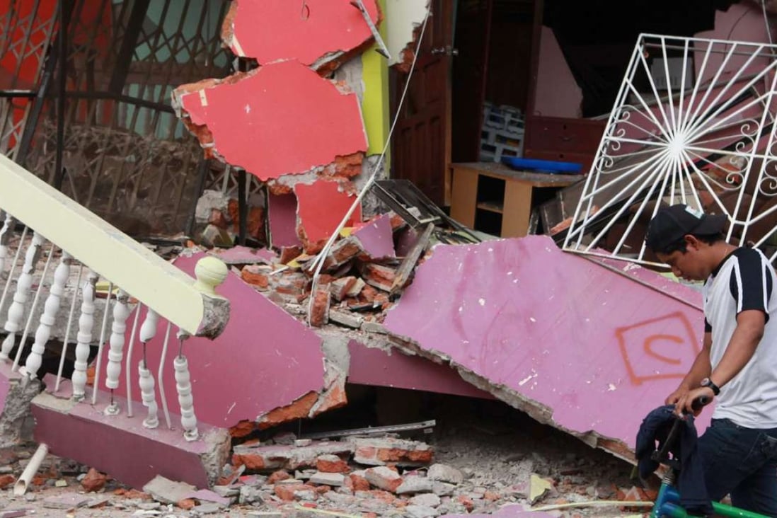 A man walks past a house that collapsed in a recent earthquake in Manta, Ecuador. Photo: EPA