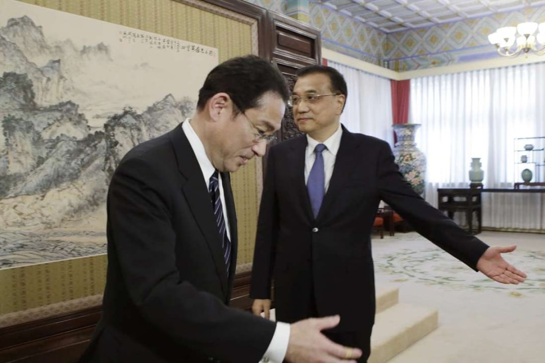 China's Premier Li Keqiang (right) shows the way to Japanese Foreign Minister Fumio Kishida during a meeting at the Zhongnanhai leadership compound in Beijing on Saturday. Photo: AP