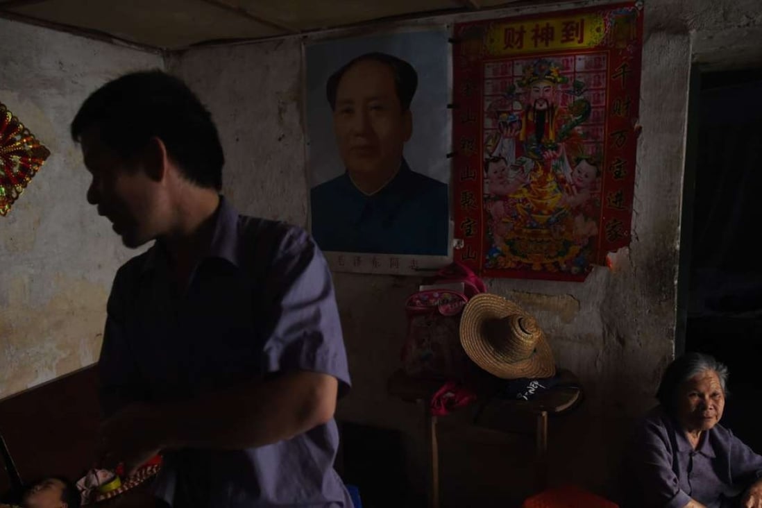 A family home in Wuxuan with a picture of Mao Zedong hanging on the wall. Mao launched the Cultural Revolution, which caused a decade of political turmoil in China. Photo: AFP