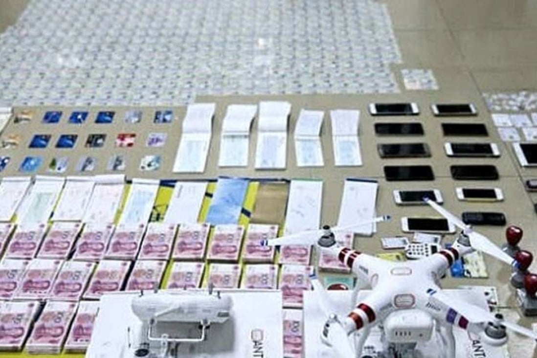 Shenzhen police display the drone, cash and credit cards they seized. Photo: SCMP Pictures