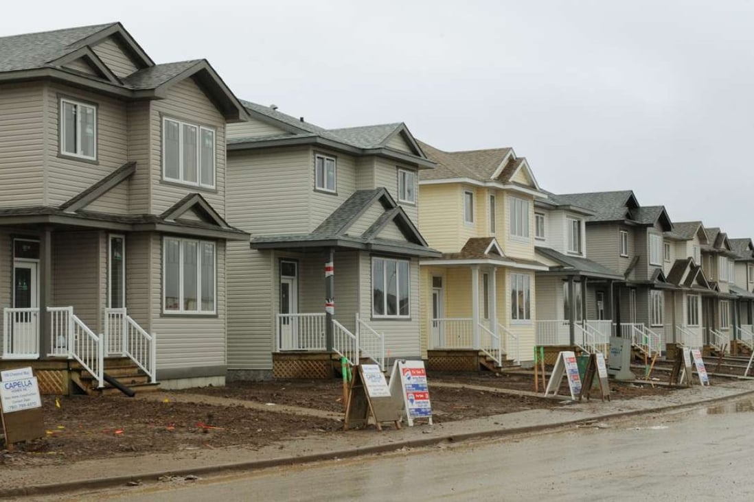 Quantitative easing by key economies is providing much of the needed fuel firing up the Canadian property real estate market. Photo: AFP Houses for sale at a new property development in the oil-sands-rich boomtown of Fort McMurray in Alberta on October 24, 2009. At an estimated 175 billion barrels, Alberta's oil sands are the second largest oil reserve in the world behind Saudi Arabia, but they were neglected for years, except by local companies, because of high extraction costs. Since 2000, skyrocketing crude oil prices and improved extraction methods have made exploitation more economical, and have lured several multinational oil companies to mine the sands. AFP PHOTO/Mark RALSTON