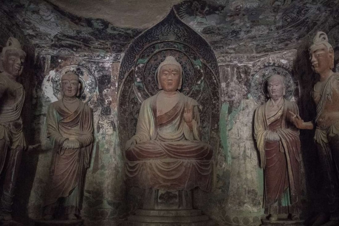 Statues of Buddha and his disciples dating from the Tang Dynasty, in one of the Mogao caves. Photo: Gilles Sabrié/The Washington Post