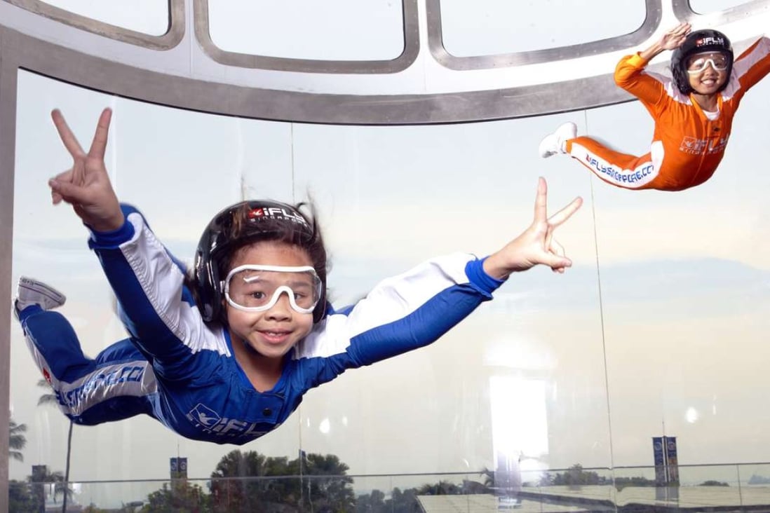Kids take flight in Siloso’s iFly Singapore, the world’s largest themed wind tunnel for indoor skydiving.