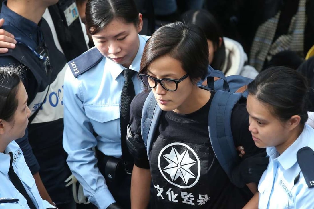 Denise Ho was taken away by police officers while barricades were removed and tents torn down at the end of Occupy Central in Admiralty. Photo: K. Y. Cheng