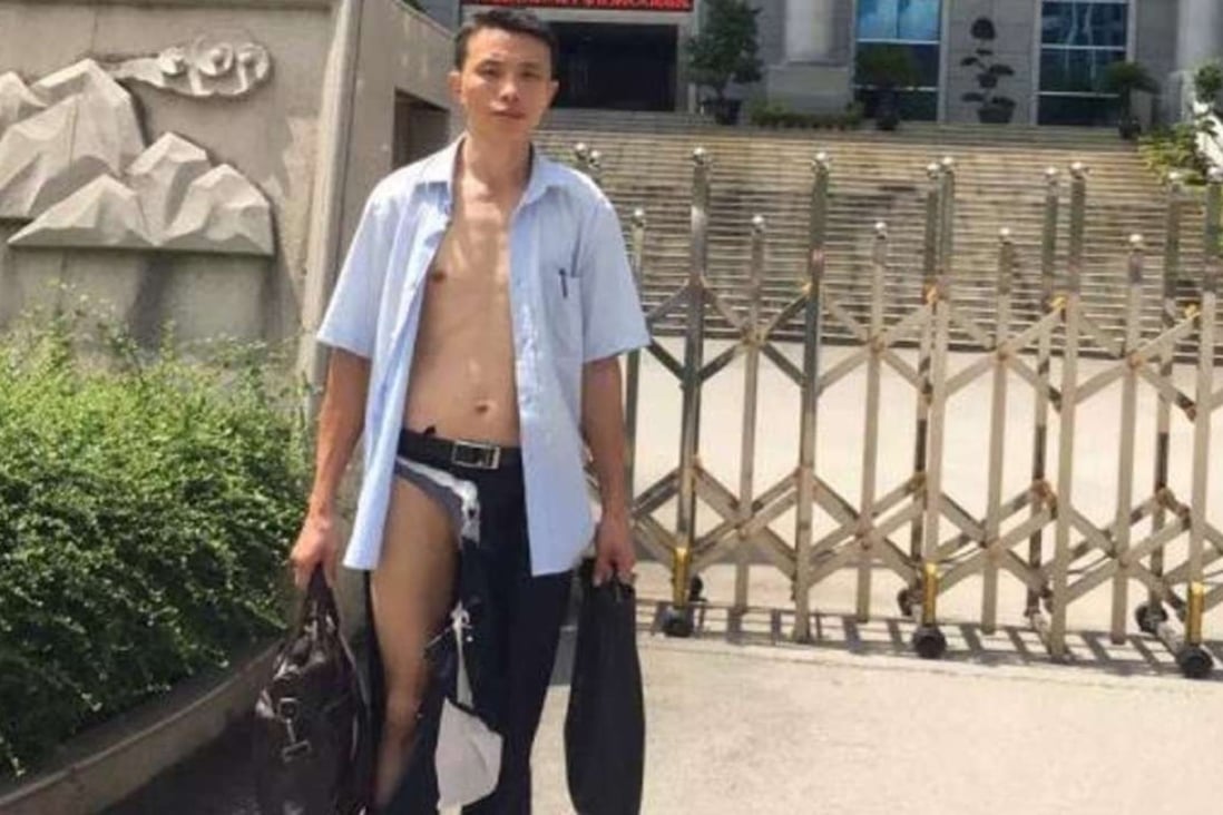 Lawyer Wu Liangshu walked out of a Qingxiu district court half-naked claiming he was beaten by three court policemen. File Photo