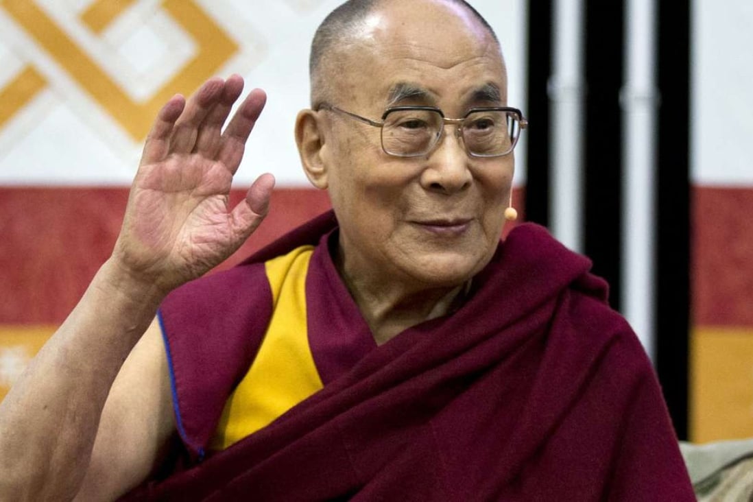 The Dalai Lama waves during an event at American University's Bender Arena in Washington on Monday. Photo: AP