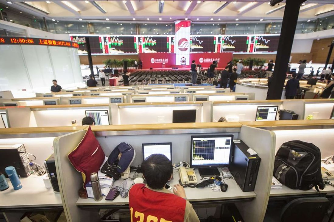 A trader sits in front of a computer at the Shanghai Stock Exchange. Officials there are working with their London counterparts to create a trading link between the two exchanges. Photo: Qilai Shen, Bloomberg
