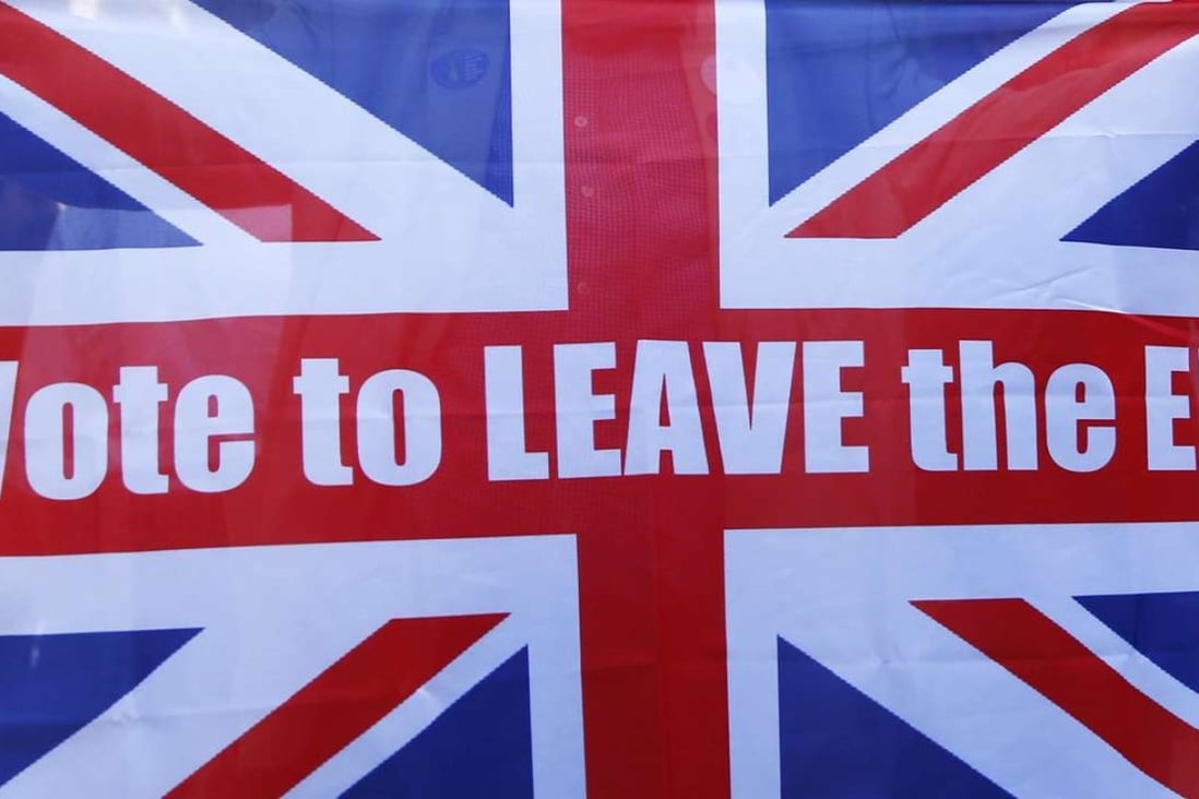 A vote Leave supporter holds up a Union flag outside Downing Street. Photo: Reuters