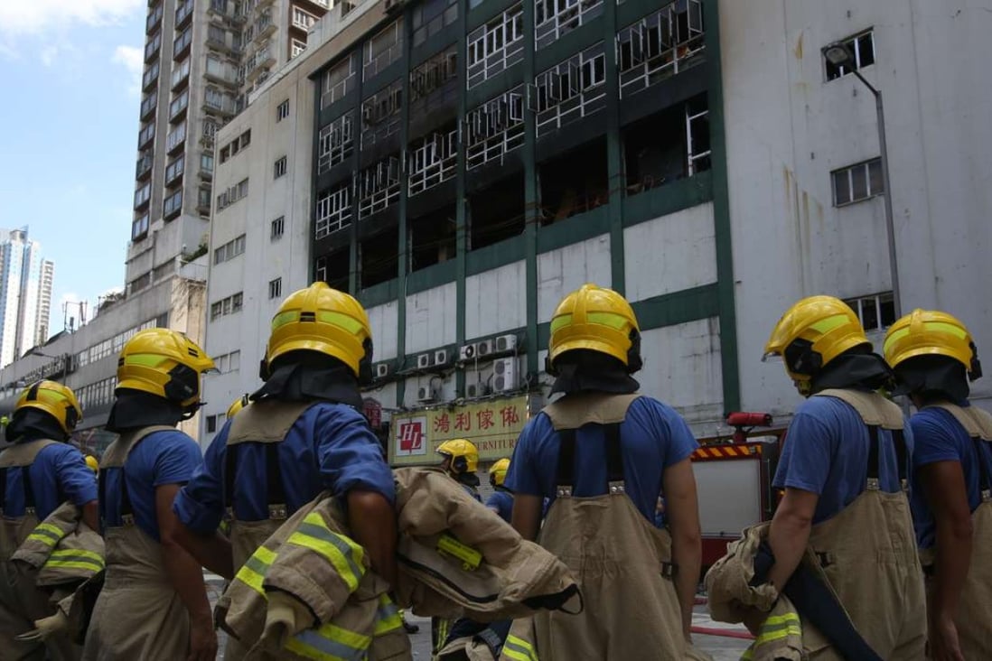 Firemen battled heavy smoke and flames as they broke open each storage cubicle inside the building. Photo: Sam Tsang