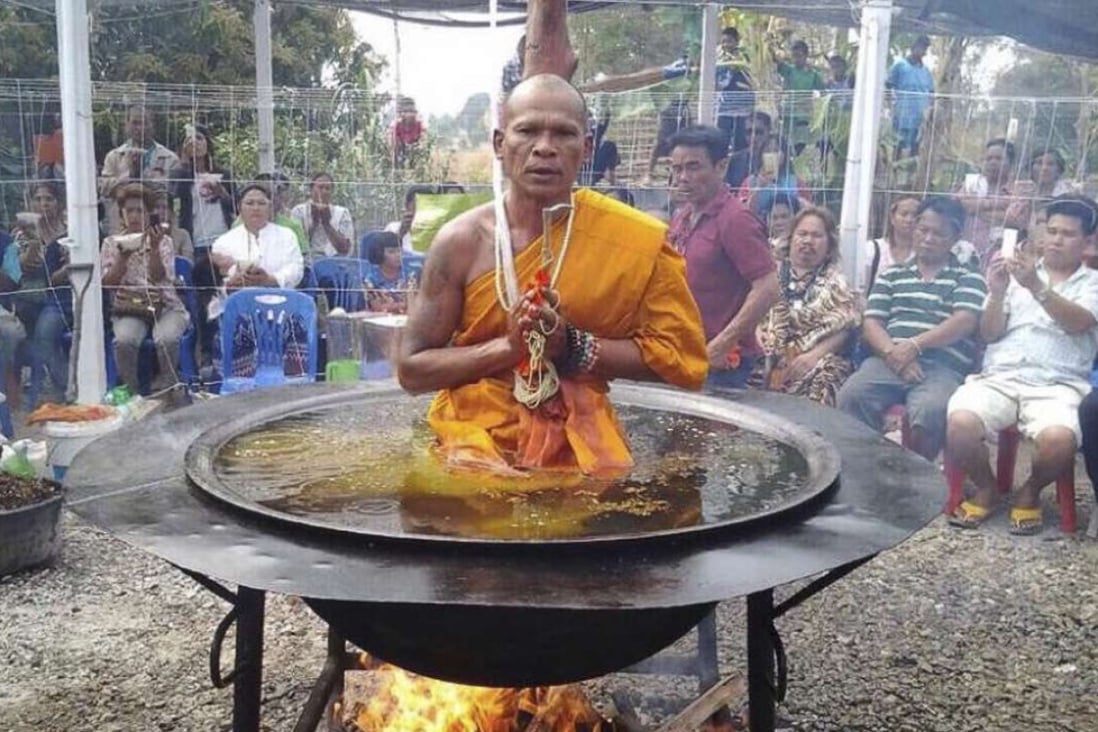 A monk sits in a vat of “boiling oil” in Thailand’s Nong Bua Lamphu province.
