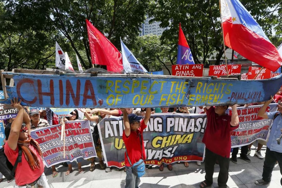 Protesters display a broken fishing boat with a message during a rally outside of the Chinese Consulate hours before the Hague-based UN international arbitration tribunal is to announce its ruling on South China Sea. Photo: AP