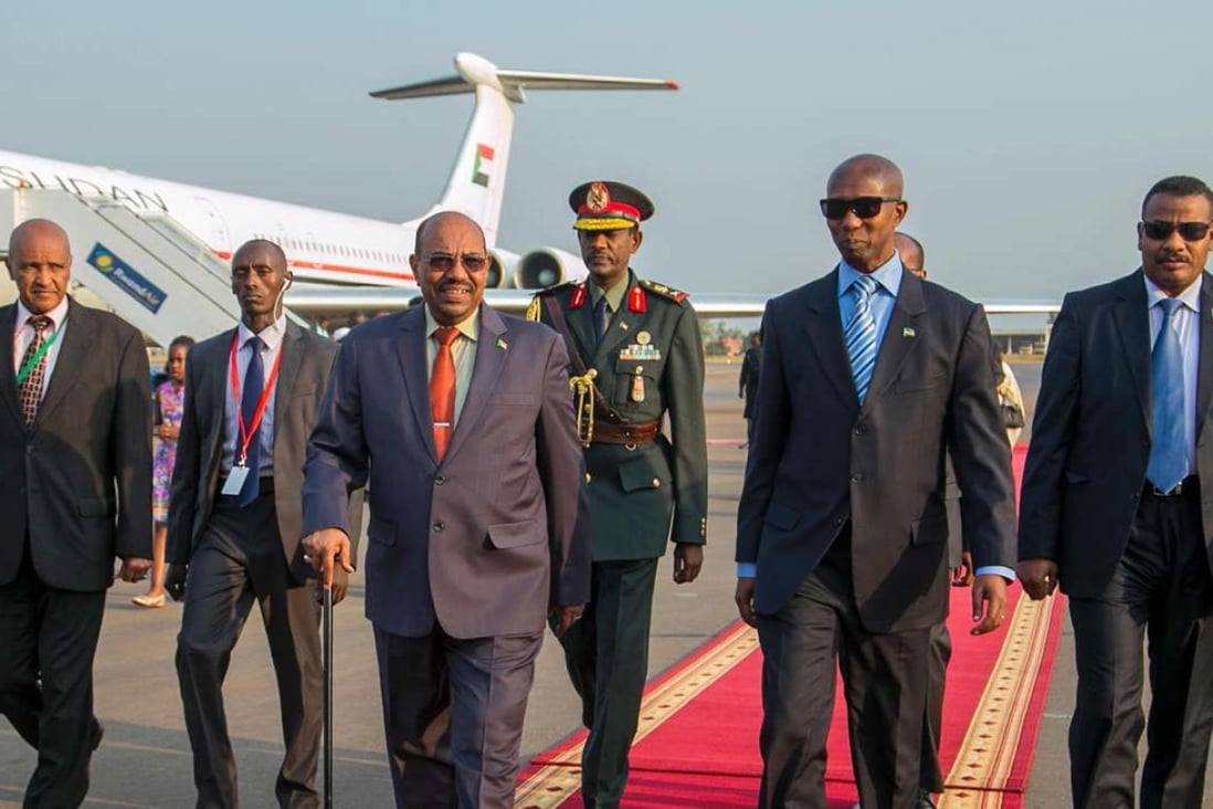 Sudan’s President Omar Hassan Ahmad al-Bashir (centre) arrives for the 27th African Union summit at the Kigali International Airport. Photo: AFP