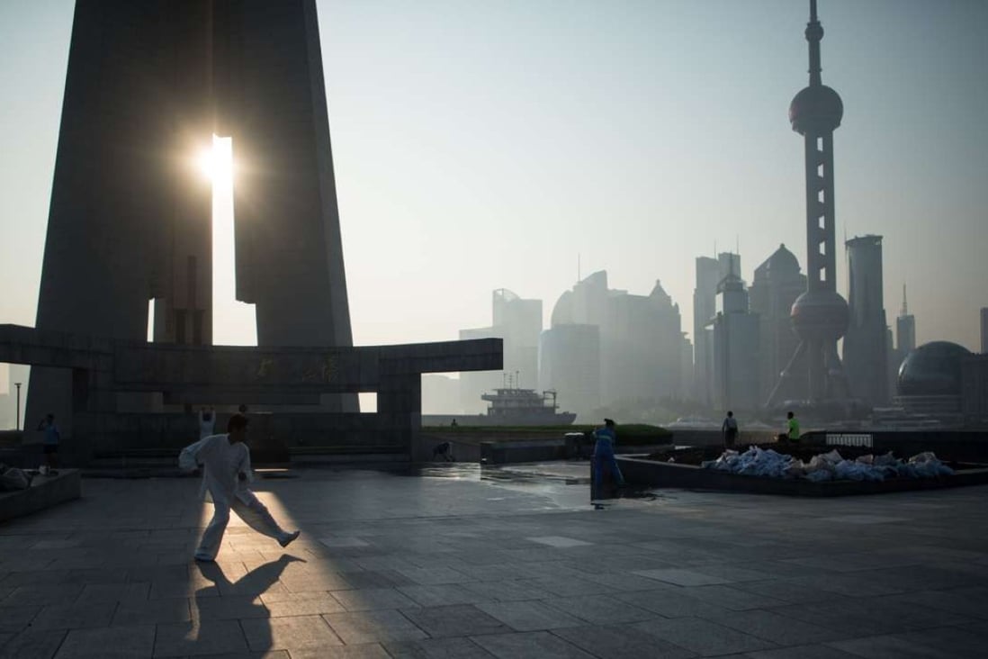 A man exercises in front of the financial district of Lujiazui in Shanghai. Photo: AFP