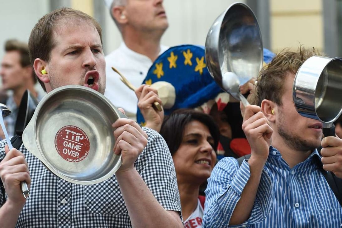 Activists bang on pans during a protest against the Transatlantic Trade and Investment Partnership in front of the EU commission building in Brussels on July 12, 2016. Photo: AFP