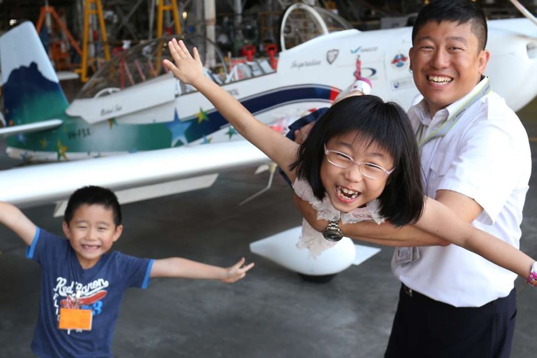 Pilot Hank Cheng Chor-hang, his son Cheng Yui-leung (left), and daughter Cheng Yui-yee, 8, with the plane that Cheng will fly across 50 countries. Photo: Dickson Lee