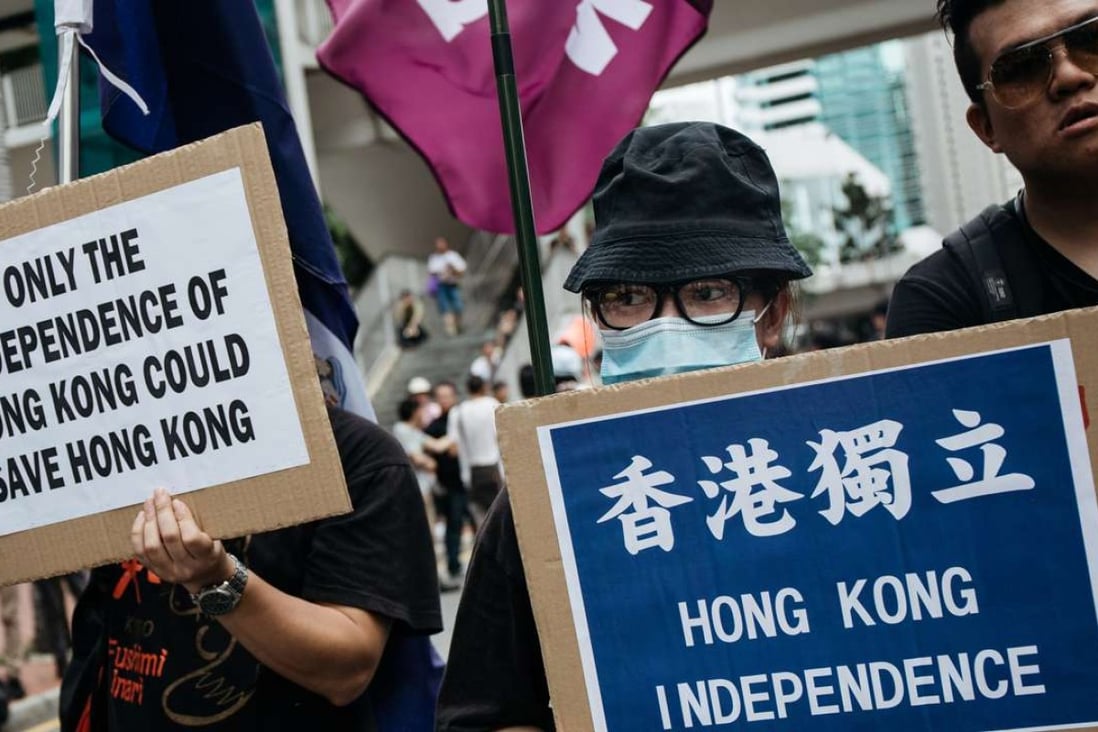 Protesters hold placards calling for Hong Kong’s independence during a rally on July 1. Photo: Bloomberg