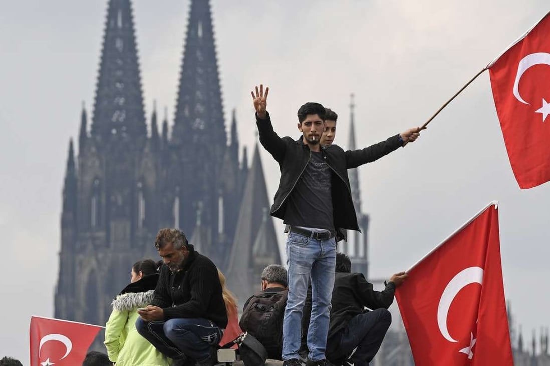 Turkish protesters demonstrate in Cologne, Germany, on Sunday in support of Turkish President Recep Tayyip Erdogan. Photo: AP