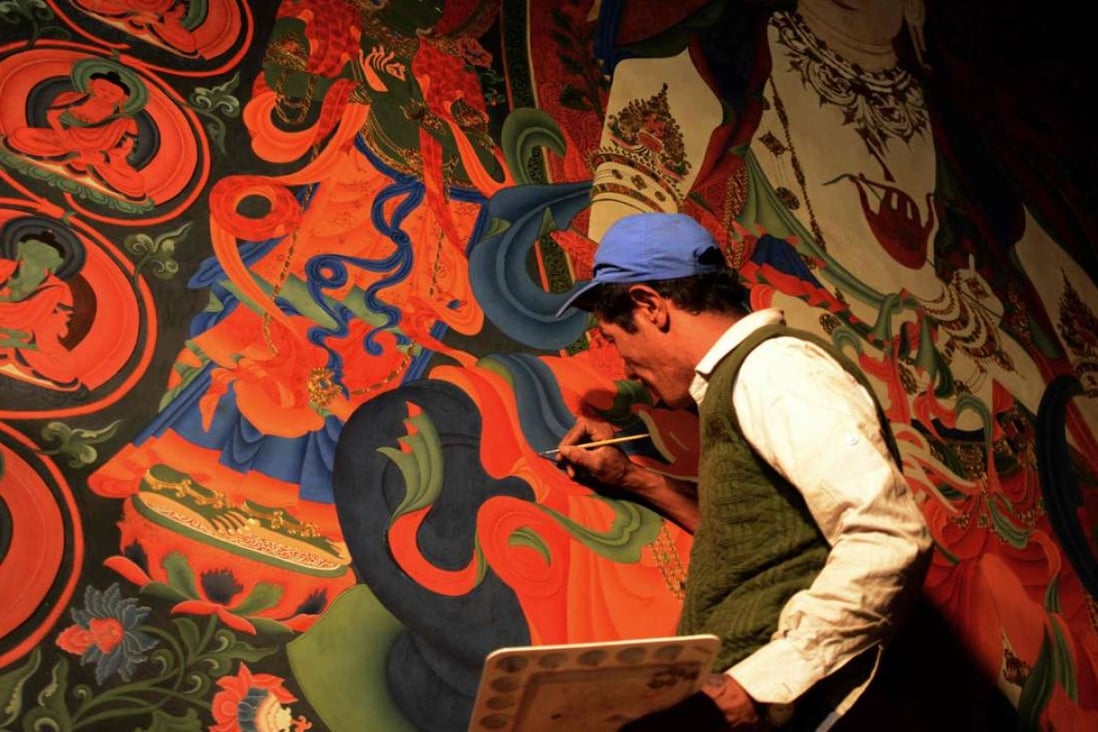 A Nepalese artist restores sacred murals in a monastry in Lo Manthang in Upper Mustang. Photo: AFP