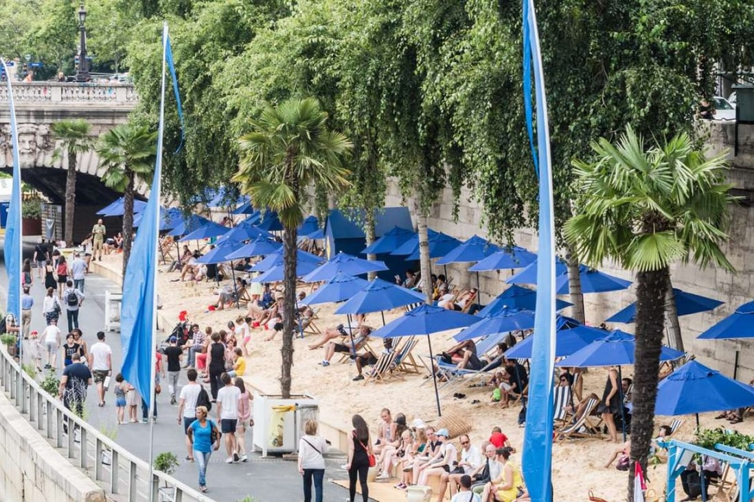 Tourists and Parisians enjoy sunbathing at an artificial beach on a Paris Plage area along the bank of the river Seine in Paris, France. Photo: EPA