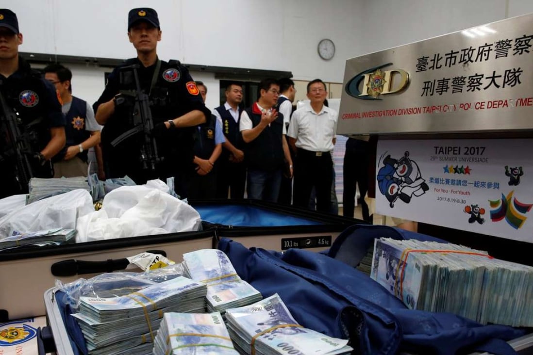 Police display Taiwanese banknotes found in a hotel room rented by one of the suspects. Photo: Reuters