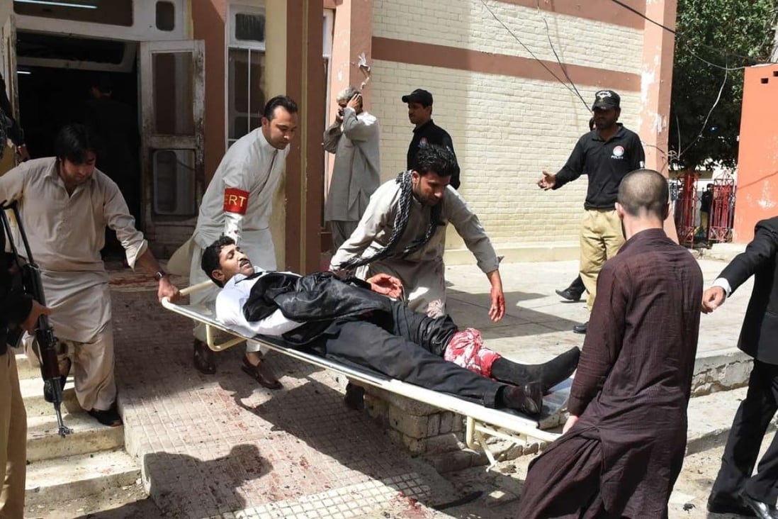 Pakistani volunteers use a stretcher to move an injured lawyer after the suicide bomb in Quetta. The regional arm of Islamic State claimed responsibility for the attack. Photo: AFP